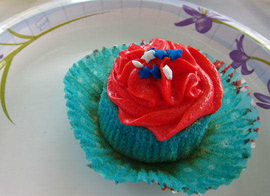 blue vanilla cupcake with red vanilla buttercream icing